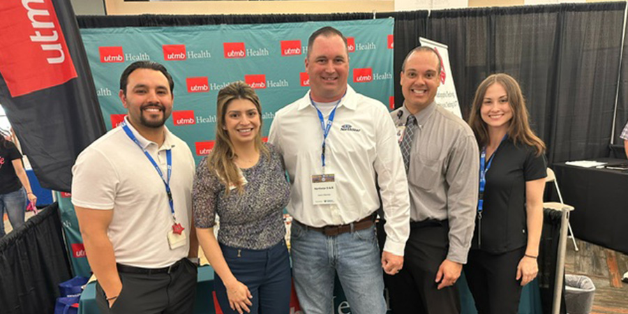 Group of UTMB employees with Justin Wenner, former UTMB patient