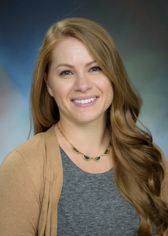 Dr. Kimberly Gushanas Headshot Image of clinical psychologist Dr. Kimberly Gushanas - a female clinician wearing a gray shirt and brown cardigan