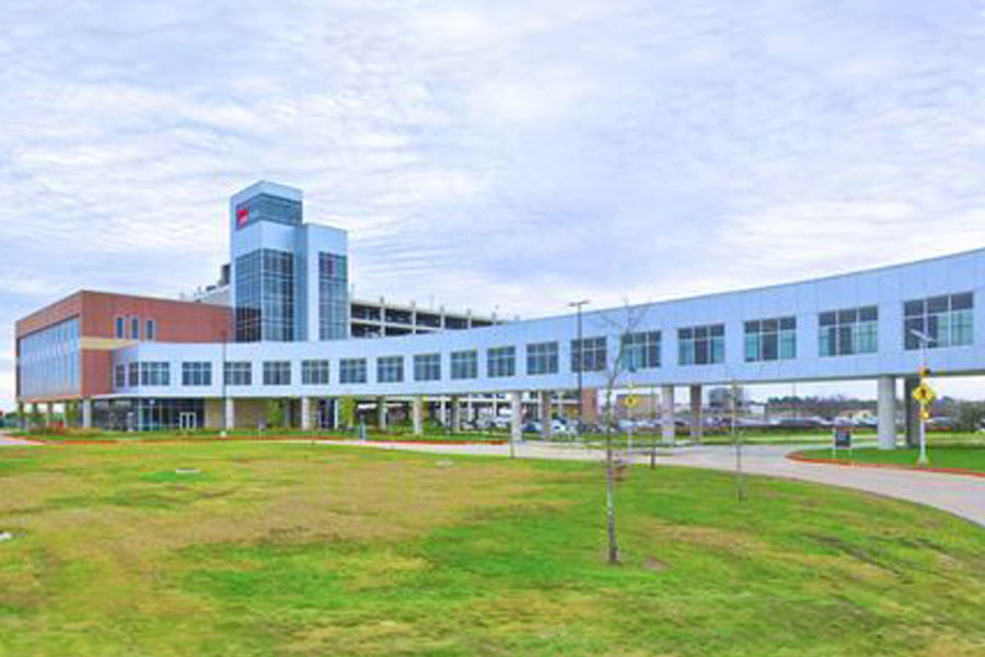 Exterior of UTMB Health League City Clinic on partly cloudy day