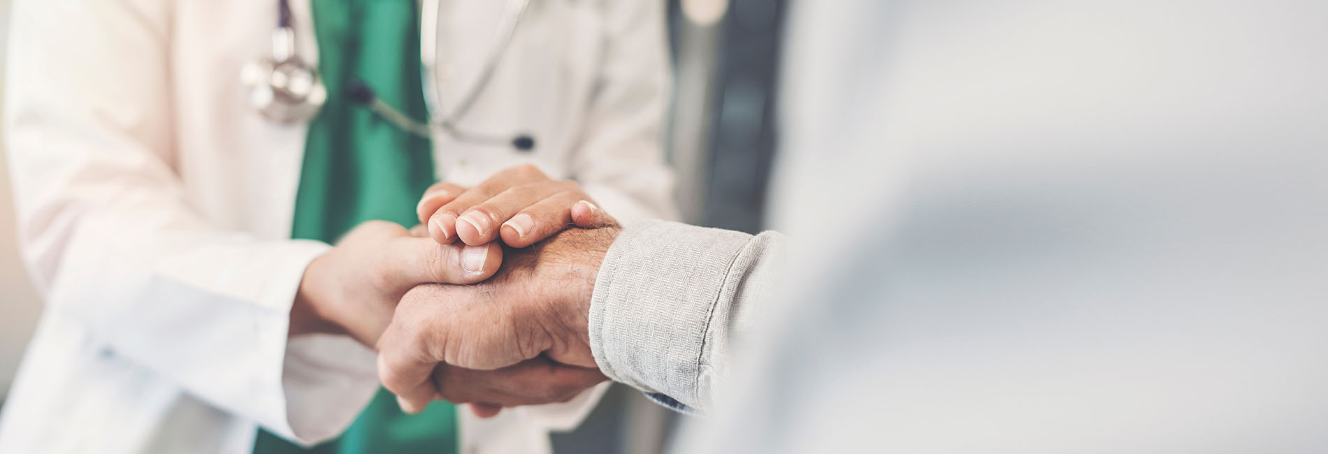 Doctor holding patient's hand