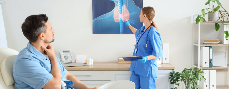 Female endocrinologist showing picture of thyroid gland to patient in clinic