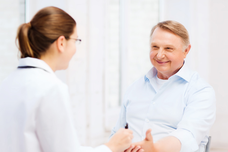 Female doctor checking blood sugar level of male patient