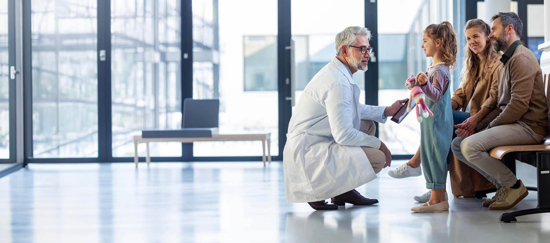 A neurosurgeon speaks with a family during a consultation for Chiari malformation at UTMB Health.