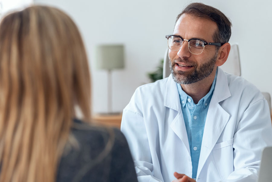 A neurosurgeon consults with a patient in a clinic setting, discussing symptoms and treatment options for neurological conditions.