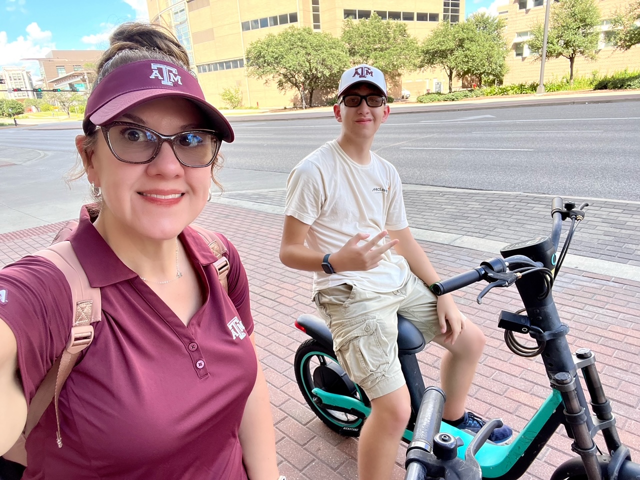 UTMB patient Felicity Cunningham riding an electric bicycle next to her teenage son