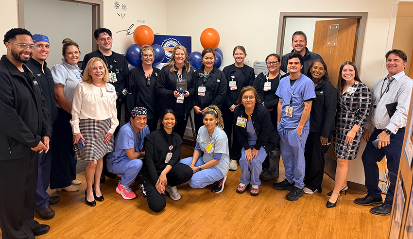 LCC 4 South received the inpatient award for the second quarter. Nineteen people from the LCC 4 South team, some wearing scrubs and some in casual business attire, pose casually in a group photo.