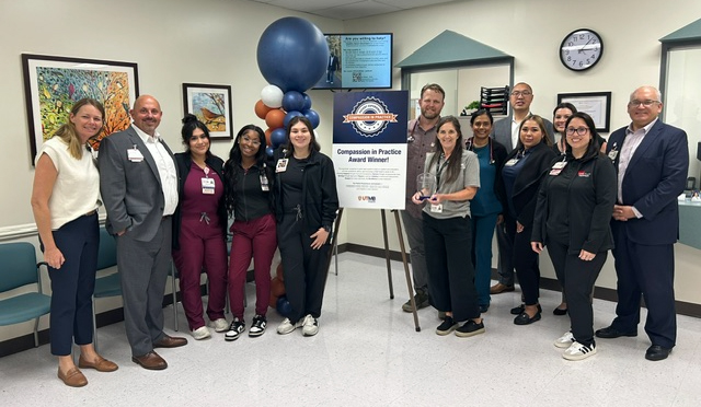 CBC PCP Galveston Primary Care received the ambulatory award for the second quarter. Thirteen UTMB Health staff members, some wearing scrubs and some in business attire, pose with celebratory balloons.