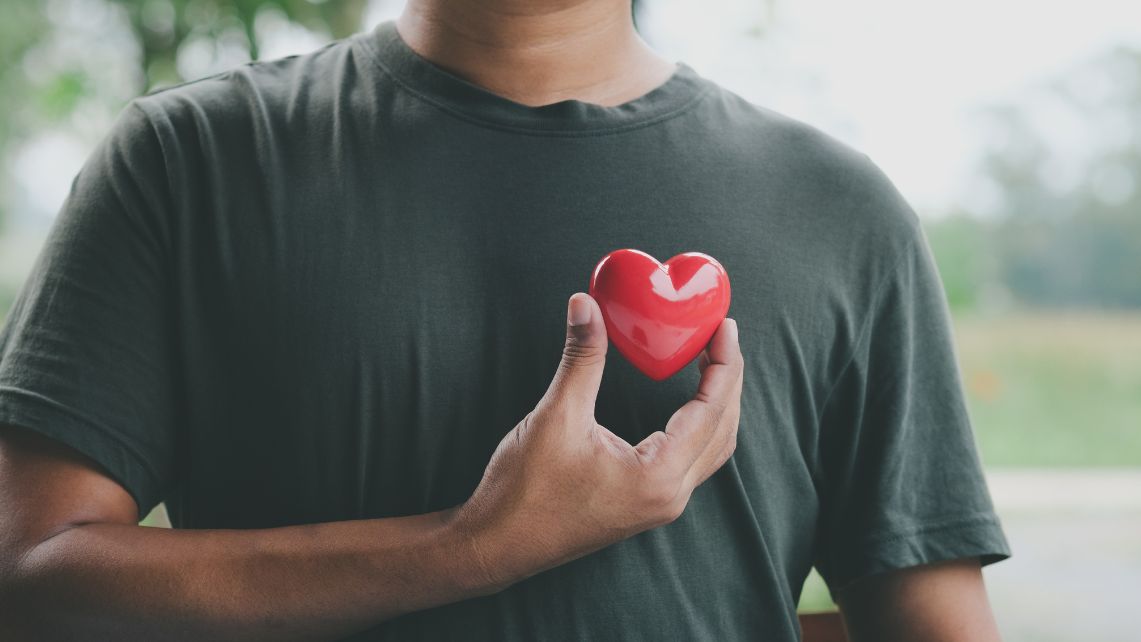 Man holding toy heart