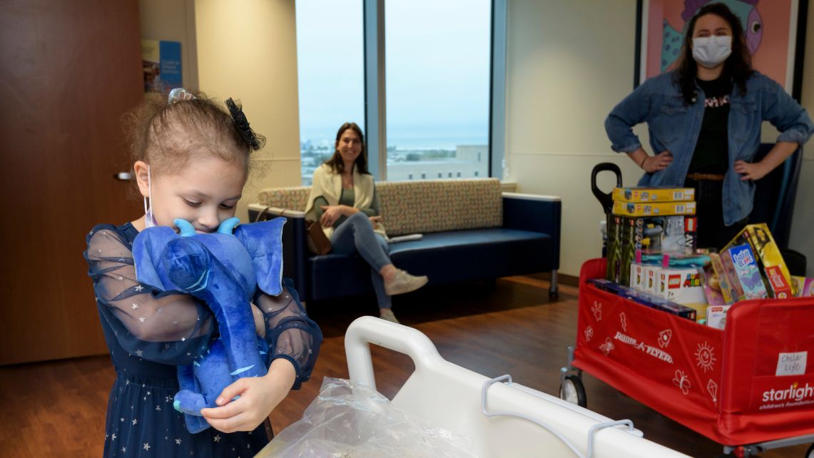Starlight Donation 2 A young girl squeezes a stuffed toy donated by Tantrum Merch and nonprofit Starlight Children’s Foundation