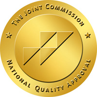 Gold circular badge displaying The Joint Commission’s National Quality Approval seal.