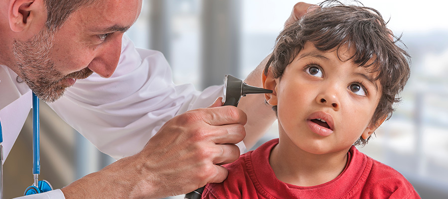 doctor looking in boy's ear